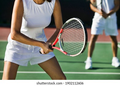 Tennis Players Playing A Doubles Match