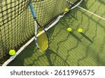 Tennis racket and ball on green background. Flat lay. Sports equipment
