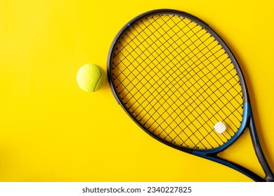 Tennis racket and tennis ball on yellow background, Top view of  ,Top view with copy space for text