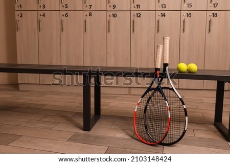 Tennis racket and balls in locker room