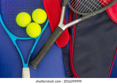 Tennis rackets with tennis balls and bag on blue surface - Powered by Shutterstock