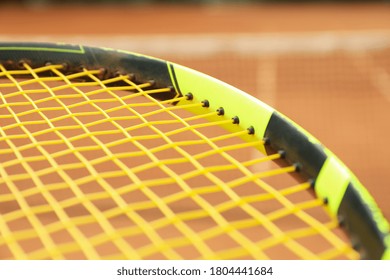 Tennis Racquet Against Clay Court, Close Up