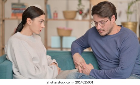 Tense Mixed Race Couple Sitting Upset At Home