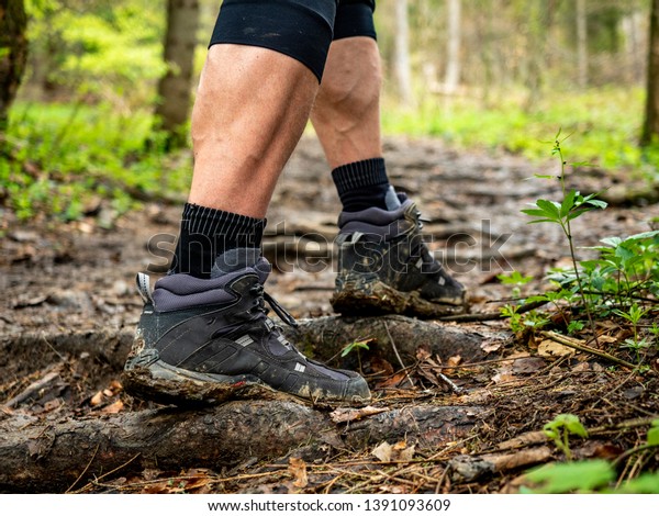 tense muscles of the traveler’s feet in muddy\
boots in the Bieszczady\
Mountains