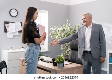 A Tense, Stressed Young Girl Comes To The Office For A Job Interview, In Hands She Is Holding Briefcase With Documents, Elegantly Dressed Serious Elderly Boss Points To Chair Asks Her To Sit Down