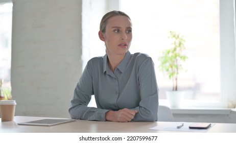 Tense Woman Feeling Frustrated While Sitting In Office