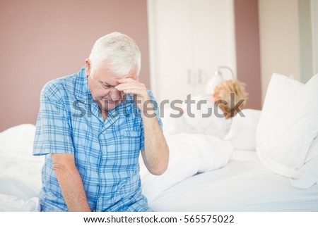 Tensed senior man in bedroom at home