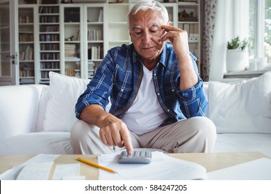 Tensed Senior Man Checking The Bills At Home