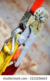 Tensioned Cargo Strap, Orange, With Ratchet Lock, Diagonal Close-up.
