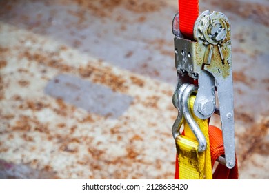 Tensioned Cargo Strap, Orange, With Ratchet Lock, Close-up.