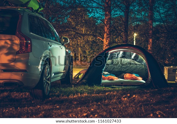 Tent Camping in the Forest.\
Traveling by Car and Camping with a Tent. Summer Travel\
Theme.
