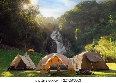 Tent and camping with Mae Tia waterfall and mountain background at inthanon national park in Chiang mai, Thailand, un seen travel point for camping and relax in holiday - Powered by Shutterstock