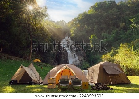 Tent and camping with Mae Tia waterfall and mountain background at inthanon national park in Chiang mai, Thailand, un seen travel point for camping and relax in holiday