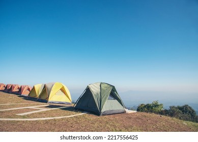 Tent Camping Trip Outdoor Hiking Mountain Hill. Tent Camp In Nature Background With Sunrise On Top Of Mountain. Picnic Tent Green Nature Campground In Forest. Adventure Travel Wildness Flare Sunlight