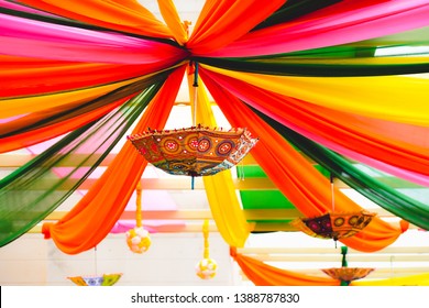 Tent decoration with cloth at a wedding ceremony with umbrellas, glass work, flower balls, and beautiful colorful cloth