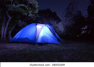 Tent Glows At Night During Camping Holiday Or Vacation In The Country. No People. Copy Space