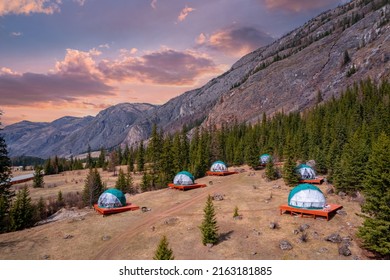 Tent houses glamping for tourism background autumn forest Altai mountains Russia with sunset. Camping aerial top view. - Powered by Shutterstock