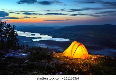 	A tent lit up at dusk