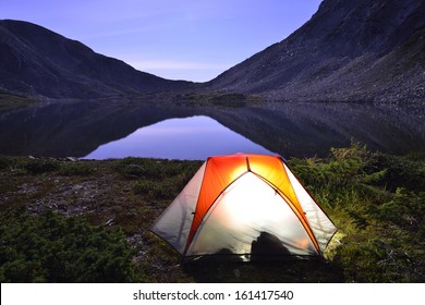 Tent On Camping Ground Near The Lake At Night During Summer