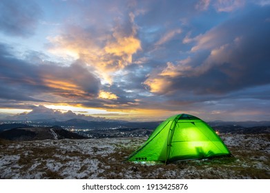 Tent on the top of the mountain against the backdrop of the sunset