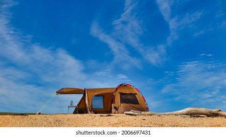 The tent on wild beach near see