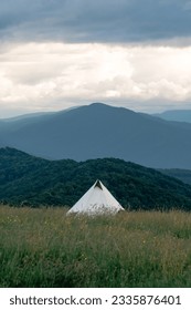 tent overlooking a mountain range at sunset