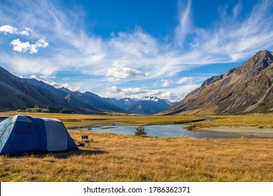 A tent pitched beside the Ahuriri River, surrounded by mountains, in Cantebury, South Island, New Zealand - Shutterstock ID 1786362371