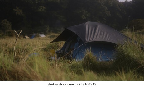 the tent is a place of refuge when doing activities in the open, this photo was taken while camping in Ciwidey, West Java with temperatures of 12 degrees Celsius and light dew that had fallen - Shutterstock ID 2258106313