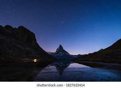 A tent at the Riffelsee, with the Matterhorn in the background, on a summers night.