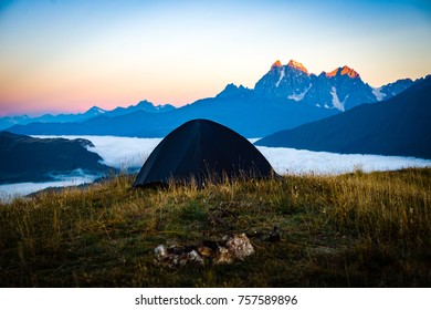 The tent stands on the background of high mountains. Around the wonderful landscape. Morning. Sunrise. Tourism in the Caucasian Mountains in Georgia. - Shutterstock ID 757589896