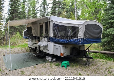 Tent trailer set up in Wooded Campground