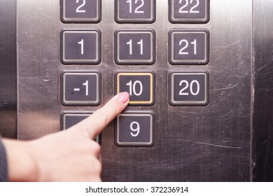 Tenth (10th) Floor Elevator Button Is Pushed By A Female Finger