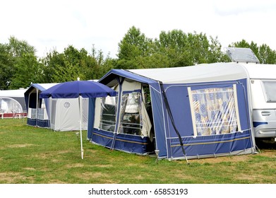 Tents And A Caravan At A Camping Site. NO PEOPLE