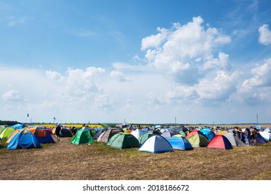 Tents On A Music Festival Campsite. Blue Sky With Clouds On Background