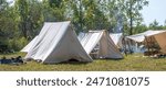 tents are set up at this civil war reenactment, showing a old fashioned camp site for soldiers during the civil war