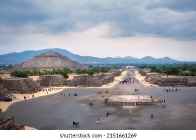 Teotihuacan, Mexico-Mar 5, 2016: Tourists visit the ruins of the ancient city of Teotihuacán. Perspective view of the Avenue of the Dead from the Pyramid of the Moon summit-Pyramid of the Sun at back.