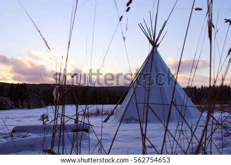 tepee in the middle of the winter forest