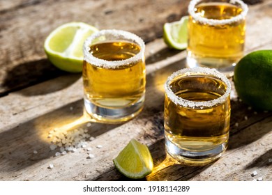 Tequila in a glass served with limes and salt. Mexican national drink.