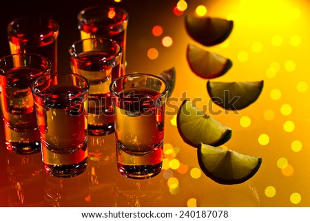 tequila and lime on a glass table