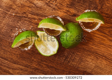 tequila , lime and salt on wooden  table selective focus