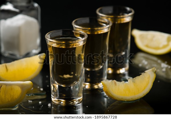 TEQUILA IN SHOT GLASS WITH\
LEMON 