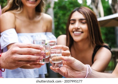 tequila shot, Group of Young latin Friends Meeting For tequila shot or mezcal drinks making A Toast In Restaurant terrace in Mexico Latin America - Shutterstock ID 2037995177