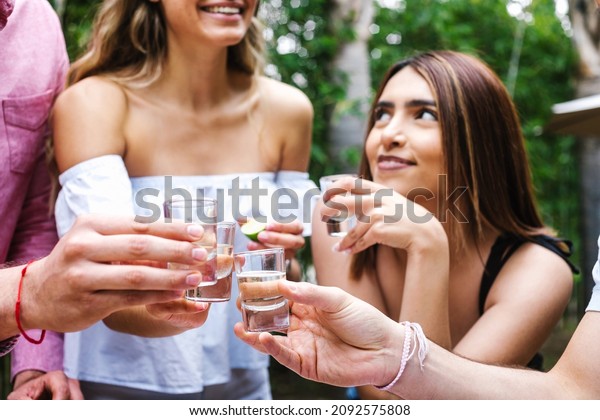 tequila shot, Group of Young latin Friends
Meeting For tequila shot or mezcal drinks making A Toast In
Restaurant terrace in Mexico Latin
America