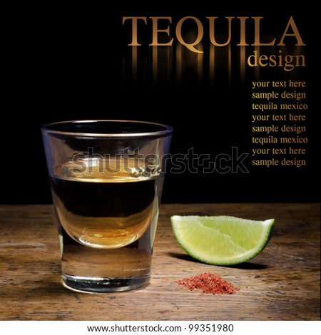 Tequila shot with lime and salt on vintage background.