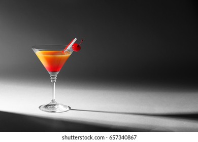 Tequila Sunrise cocktail in glass on dark background