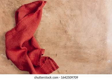 Teracotta Napkin On Beige Rustic Kitchen Table. Space For Your Recipe Or Menu. Top View.