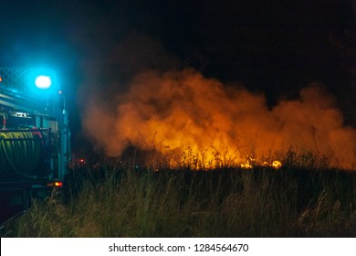 Teralba, NSW/Australia - October 24, 2012: Fire Truck At Backburning And Extinguishing A Wildfire Grass And Bushfire. Editorial Action Landscape Format