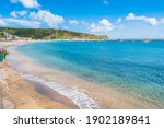 Terceira, Azores PORTUGAL - 4 August 2020 - Porto Martins with turquoise water, docks and hill in the background