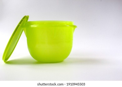 Terengganu, Malaysia - FEBRUARY 4 2021 . Green And Famous Product Of Tupperware With A White Background Along With A Blank For Writing. Keep Dry. Food Container. Container Cap. Food.