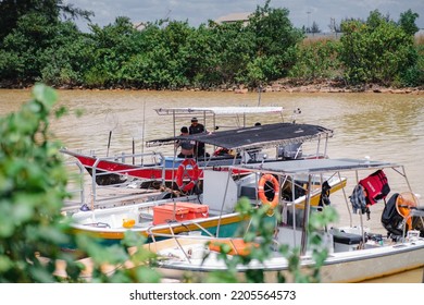 Terengganu, Malaysia - June 26, 2022 Fishermans Resting At Their Boats On The River Near Pantai Batu Buruk.